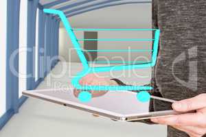 Woman holds tablet pc with shopping cart