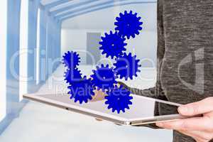 Woman holding tablet pc with gears