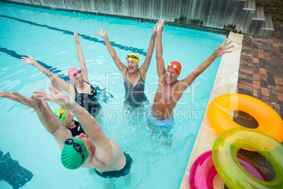 Cheerful friends enjoying in swimming pool