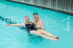 Loving mature couple enjoying in swimming pool