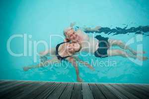 loving couple swimming in pool