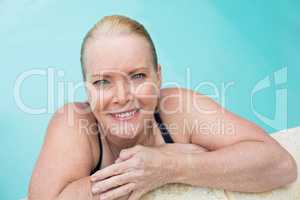 Mature woman leaning on poolside