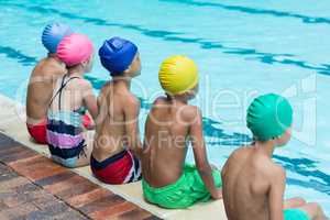 Friends sitting at poolside