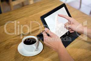 Man using digital tablet with blank screen in coffee shop