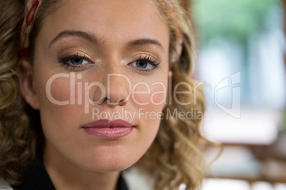 Portrait of beautiful young woman in coffee shop