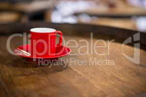 Close-up of red cup and saucer on table