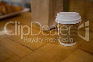 Disposable coffee cup on table in cafe