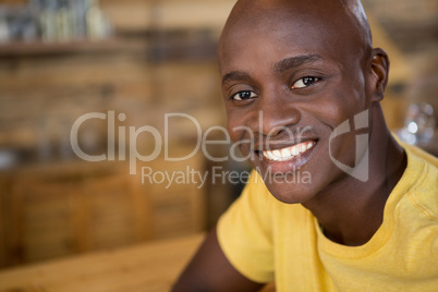 Portrait of young man smiling in coffee house