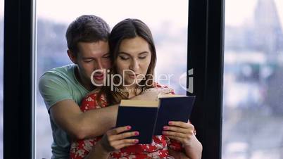 Affectionate couple spending time together reading