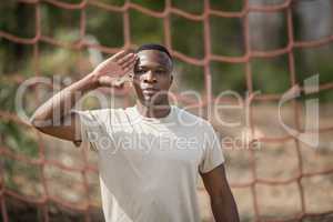 Military soldier giving salute during obstacle course