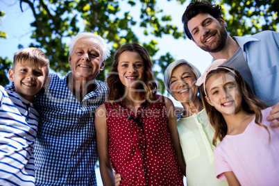 Multi generation family standing in park