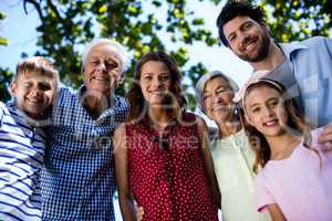 Multi generation family standing in park