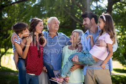 Smiling family posing together in park