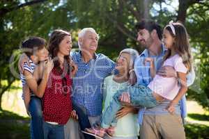 Smiling family posing together in park