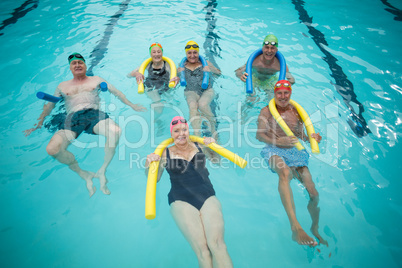 Swimmers swimming with pool noodles