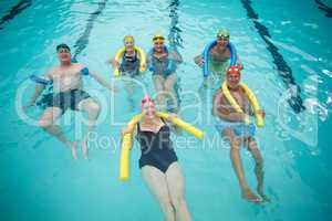 Swimmers swimming with pool noodles