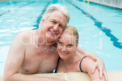 loving couple leaning at poolside