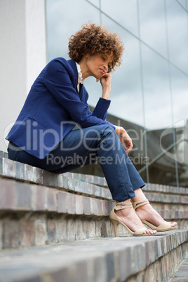 Sad businesswoman sitting in the premises