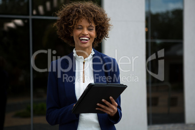 Smiling businesswoman using digital tablet