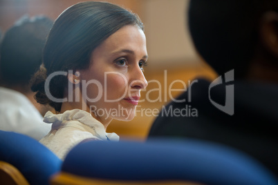 Female business executives listening to speech