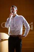 Business executive gesturing while giving a speech