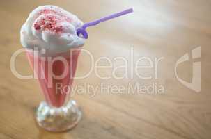 Glass of strawberry shake with cream