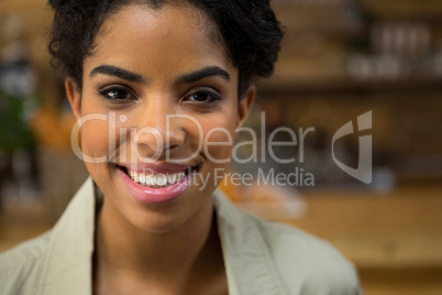 Portrait of smiling young woman in coffee shop