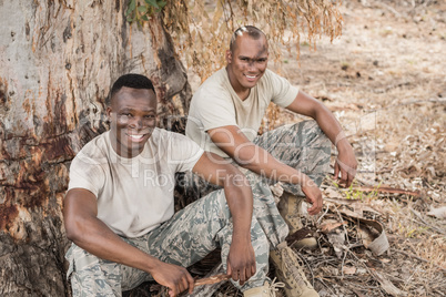 Portrait of military soldiers relaxing during obstacle training