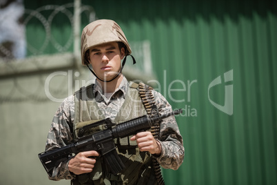 Portrait of military soldier standing with a rile