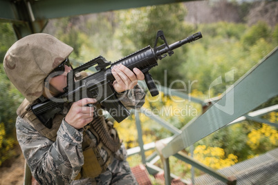 Military soldier guarding with a rifle