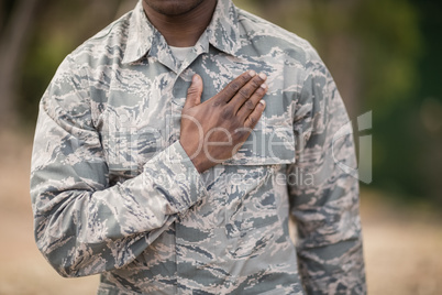 Mid section of soldier taking pledge