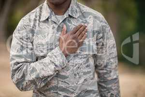 Mid section of soldier taking pledge