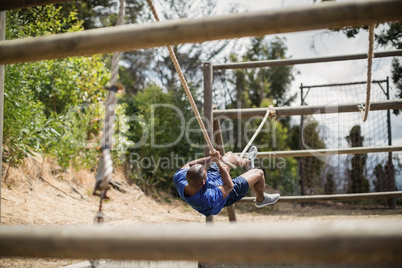 Man crossing the rope during obstacle course