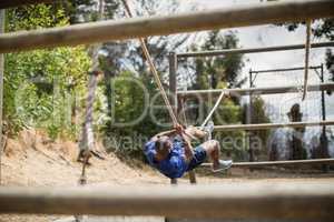 Man crossing the rope during obstacle course