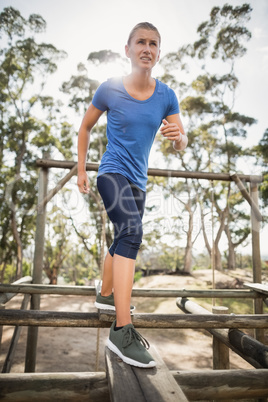 Fit woman practicing during obstacle course