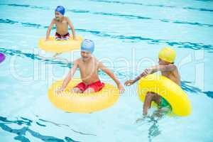 Shirtless boys swimming in pool