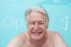 Happy senior man swimming in pool