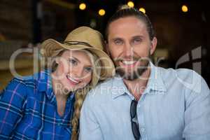 Portrait of loving couple smiling in coffee shop