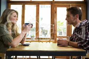 Loving young couple having coffee in cafeteria