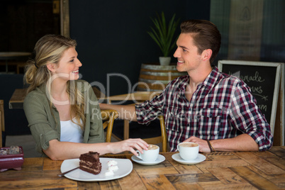 Loving couple talking at table in coffee shop