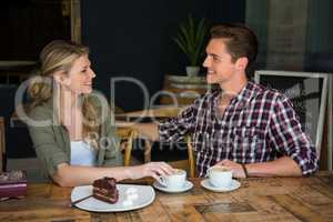 Loving couple talking at table in coffee shop
