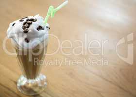 Glass of chocolate milkshake with cream in cafe