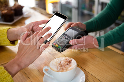 Barista accepting payment through smart phone