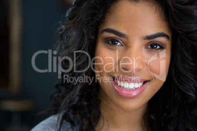 Smiling young woman in coffee shop house