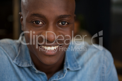 Portrait of young man smiling in coffee shop