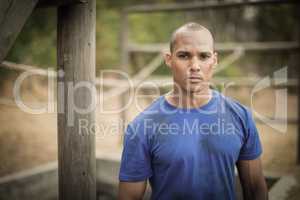 Portrait of determined man standing during obstacle course