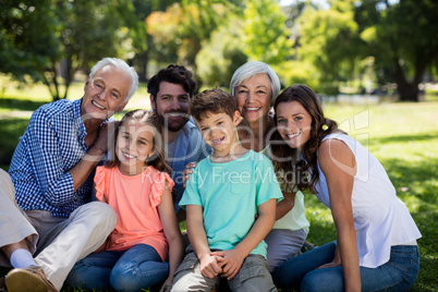 Multi generation family sitting in park