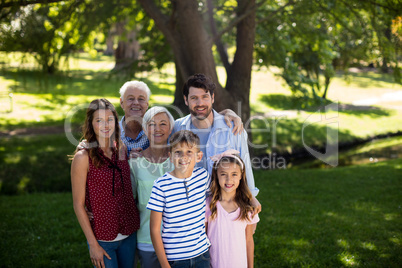 Multi generation family standing in park