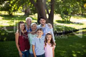 Multi generation family standing in park