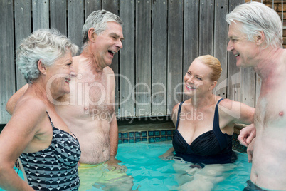 Swimmers talking while standing in swimming pool